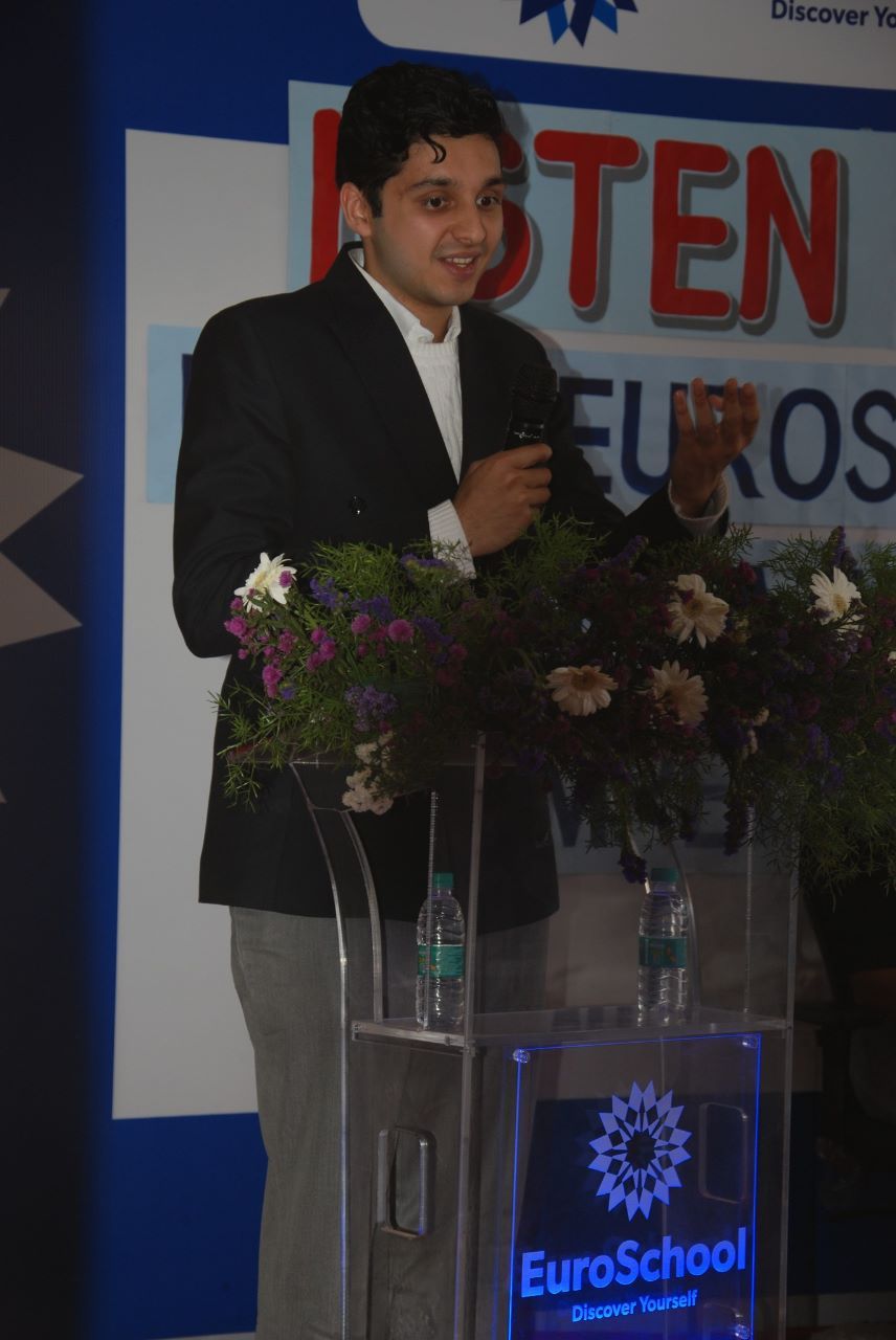 Speaking at a lectern at a school event